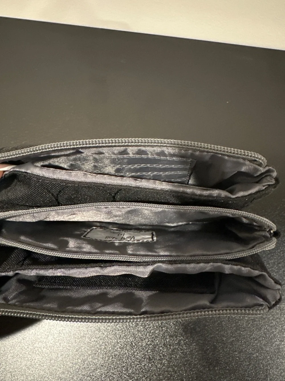Black quilted wallet with grey zipper